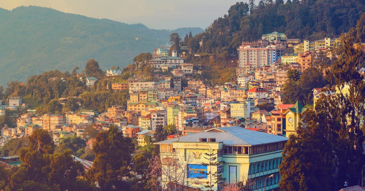 Stunning view of Gangtok, Sikkim at sunset showcasing vibrant urban landscape and scenic hills.